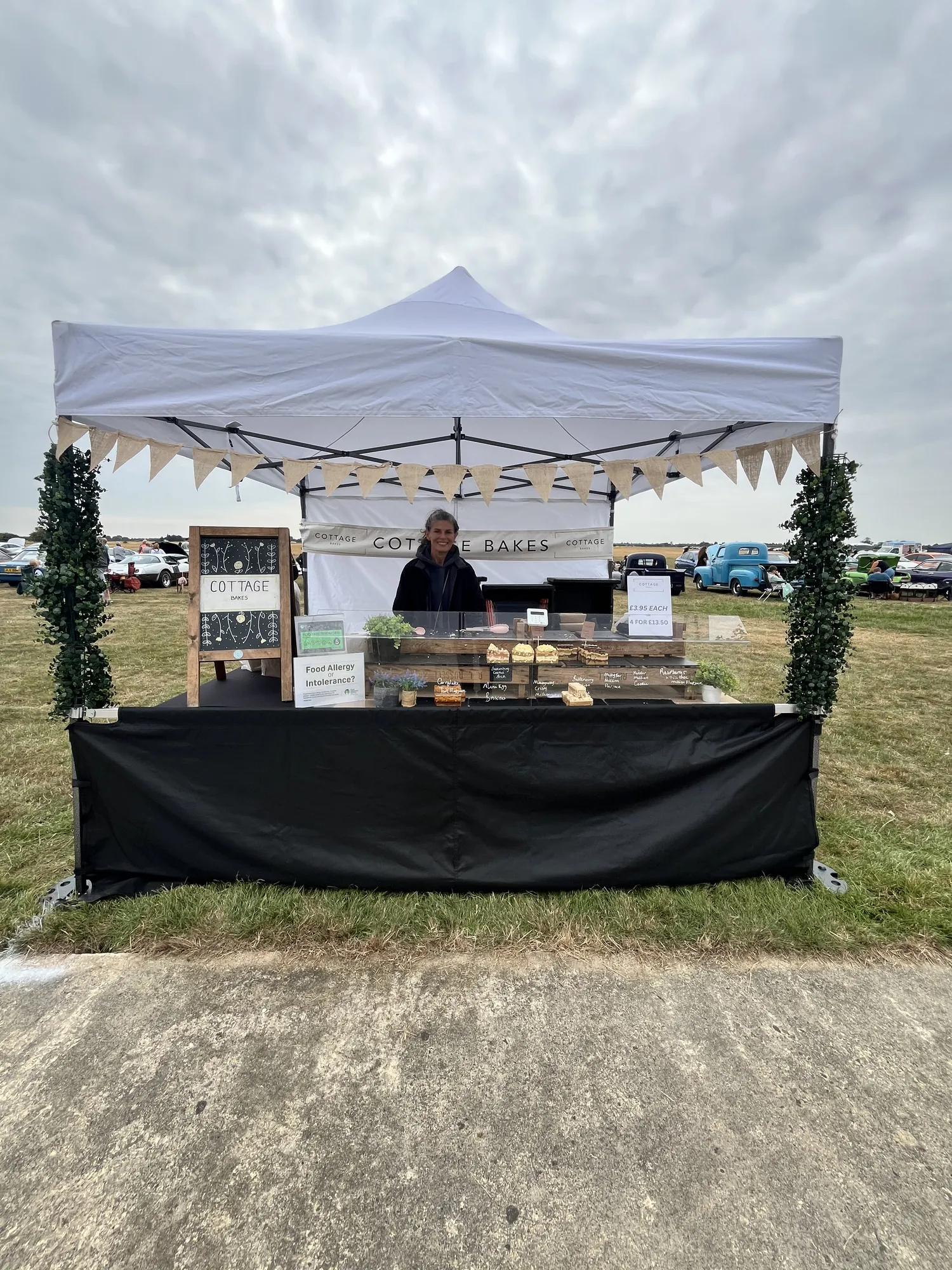 Stall selling cakes and baked goods at Wings & Wheels