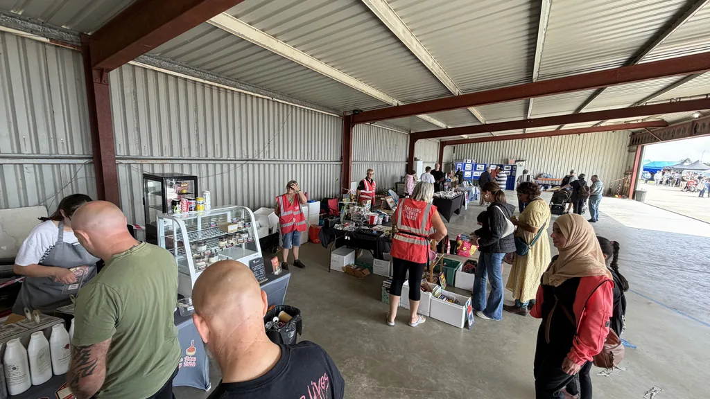 Trade stalls and visitors inside the hangar