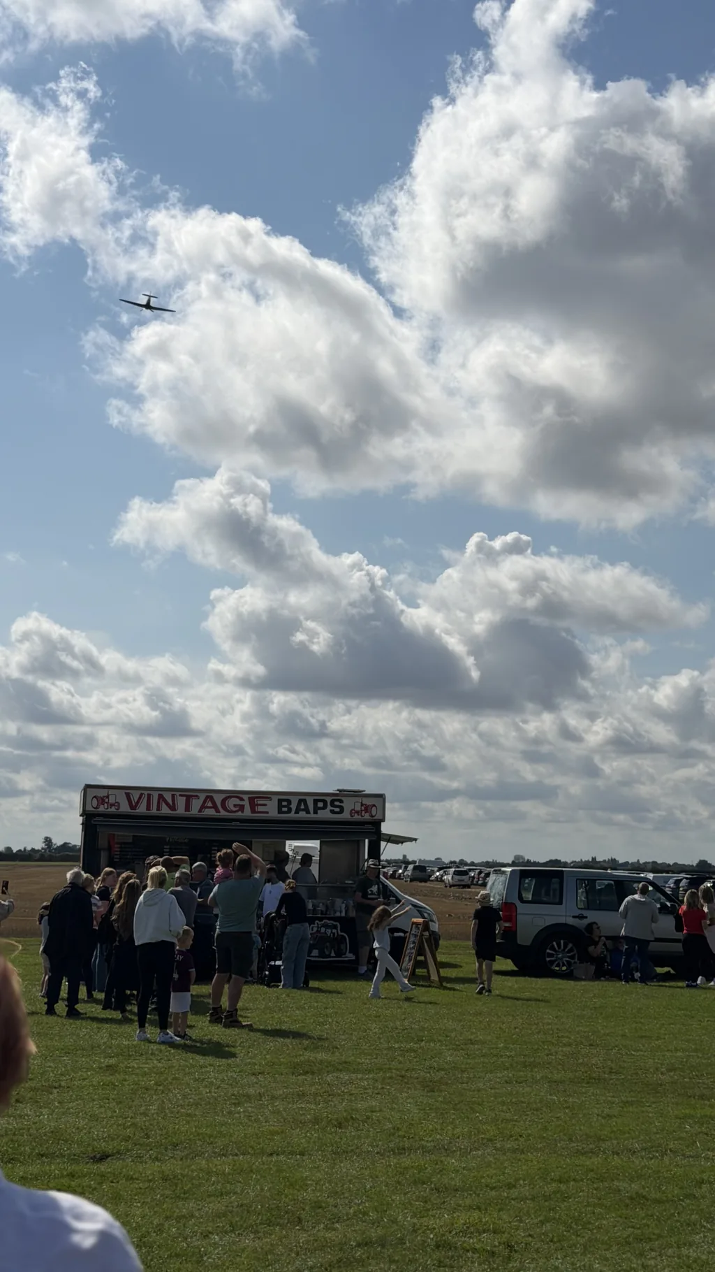The Hurricane flying over the catering vans and crowds on the airfield