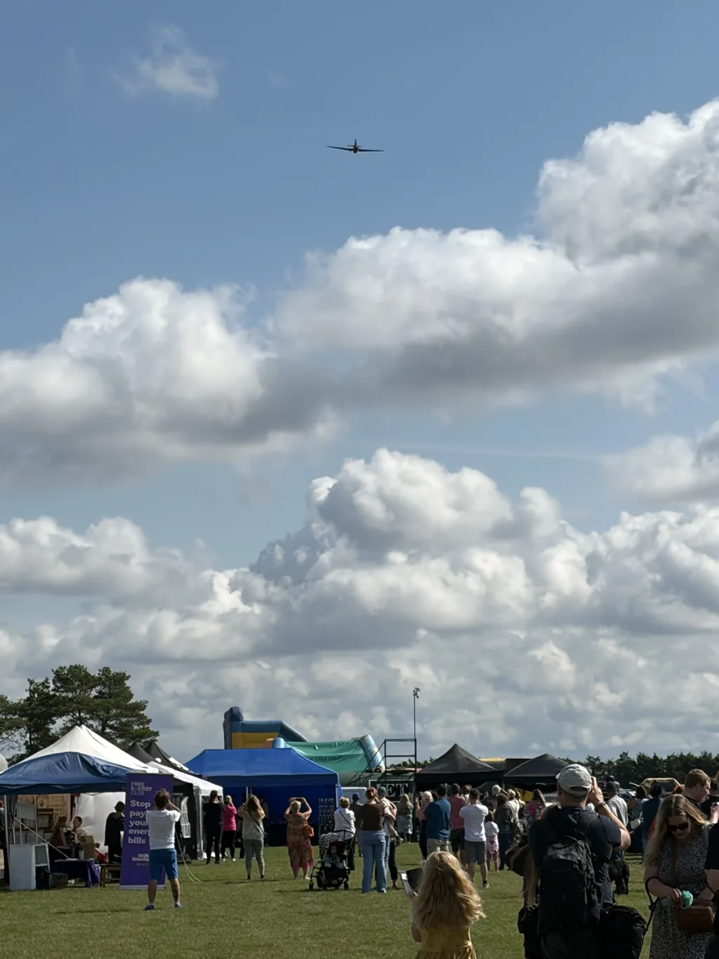 The Battle of Britain Memorial Flight Hurricane passing over the crowd and trade stands