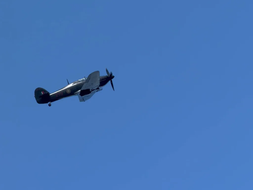 The Battle of Britain Memorial Flight Hurricane banking over Fenland Airfield, RAF roundel and fin flash visible